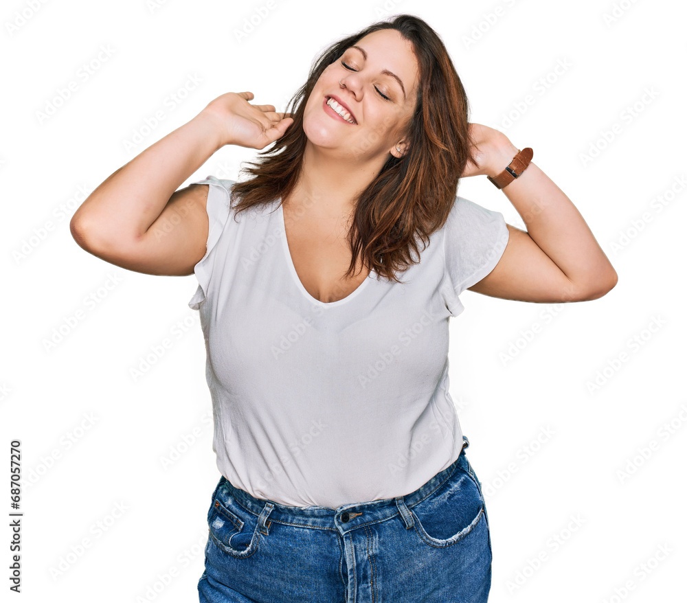 Young plus size woman wearing casual white t shirt relaxing and stretching, arms and hands behind head and neck smiling happy Young plus size woman wearing casual white t shirt relaxing and stretching, arms and hands behind head and neck smiling happy