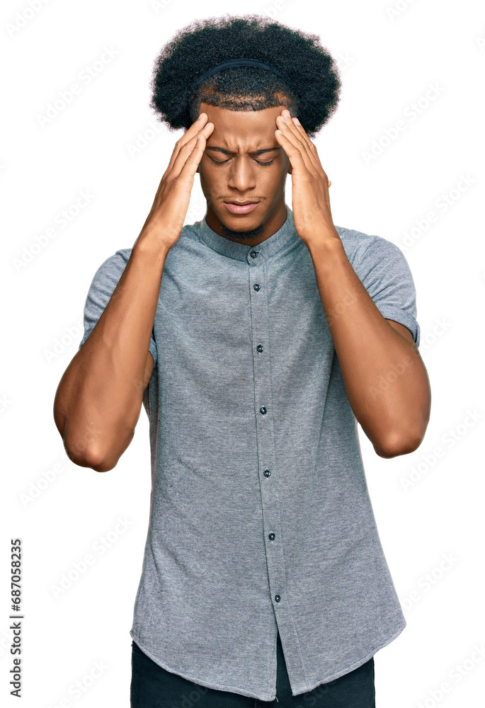 African american man with afro hair wearing casual clothes with hand on head for pain in head because stress. suffering migraine. African american man with afro hair wearing casual clothes with hand on head for pain in head because stress. suffering migraine.