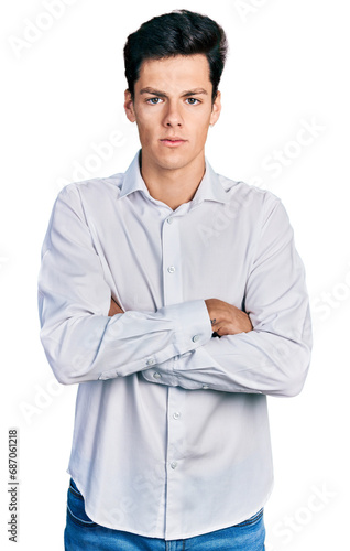 Young hispanic business man wearing business clothes skeptic and nervous, disapproving expression on face with crossed arms. negative person.