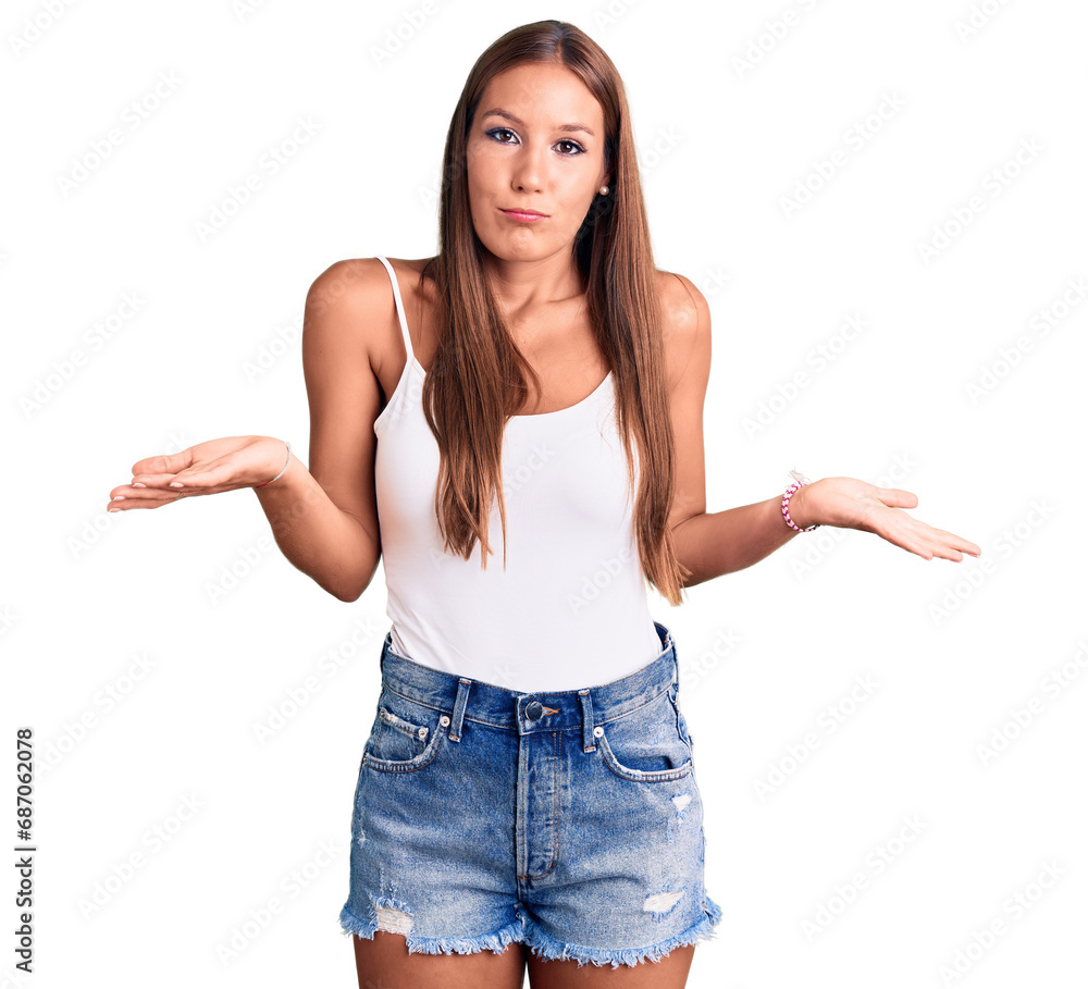 Young beautiful hispanic woman wearing casual clothes clueless and confused expression with arms and hands raised. doubt concept. Young beautiful hispanic woman wearing casual clothes clueless and confused expression with arms and hands raised. doubt concept.