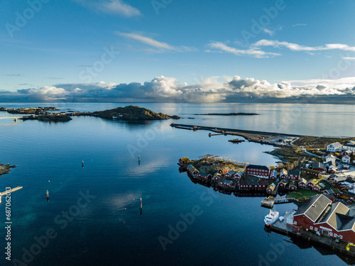 aerial view over reine nordic norwegian village surrounded with moountains with reflections on lofoten islands photo