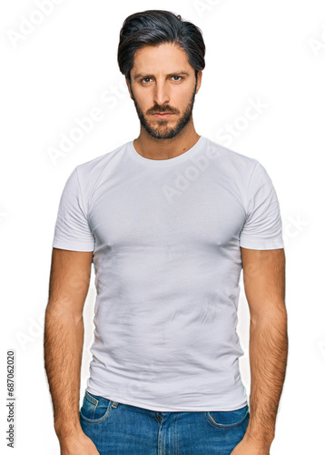 Young hispanic man wearing casual white t shirt skeptic and nervous, frowning upset because of problem. negative person.