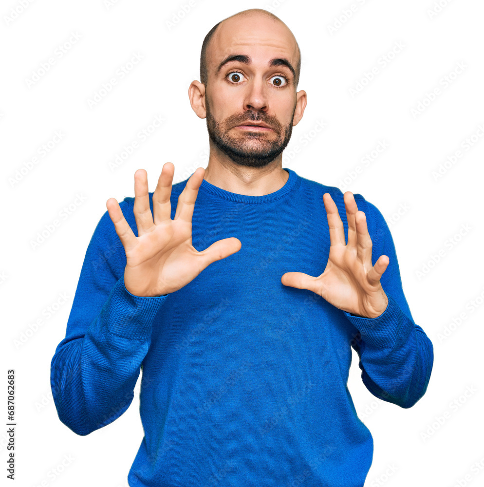 Young hispanic man wearing casual clothes afraid and terrified with fear expression stop gesture with hands, shouting in shock. panic concept. Young hispanic man wearing casual clothes afraid and terrified with fear expression stop gesture with hands, shouting in shock. panic concept.