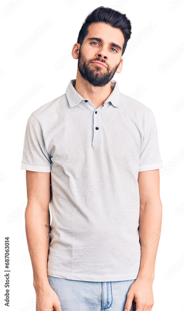Young handsome man with beard wearing casual polo relaxed with serious expression on face. simple and natural looking at the camera. Young handsome man with beard wearing casual polo relaxed with serious expression on face. simple and natural looking at the camera.
