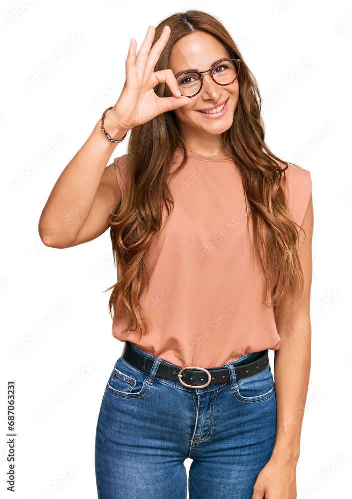 Young hispanic woman wearing casual clothes and glasses smiling positive doing ok sign with hand and fingers. successful expression. Young hispanic woman wearing casual clothes and glasses smiling positive doing ok sign with hand and fingers. successful expression.