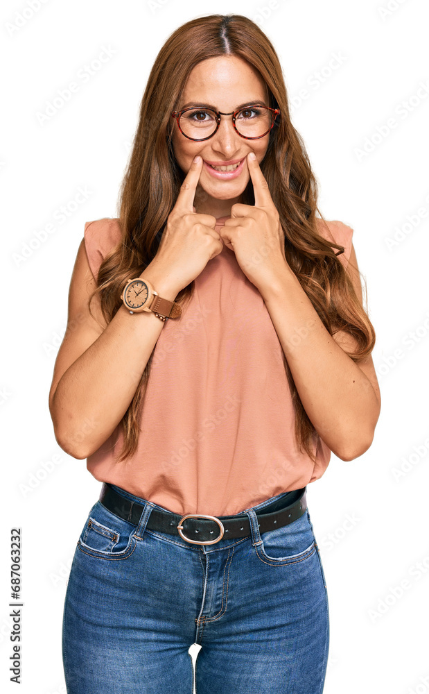 Young hispanic woman wearing casual clothes and glasses smiling with open mouth, fingers pointing and forcing cheerful smile Young hispanic woman wearing casual clothes and glasses smiling with open mouth, fingers pointing and forcing cheerful smile