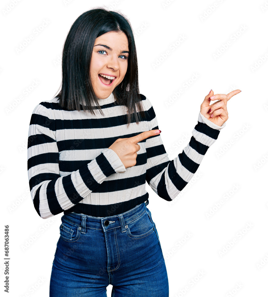 Φωτογραφία Young brunette woman with blue eyes wearing casual striped sweater smiling and looking at the camera pointing with two hands and fingers to the side