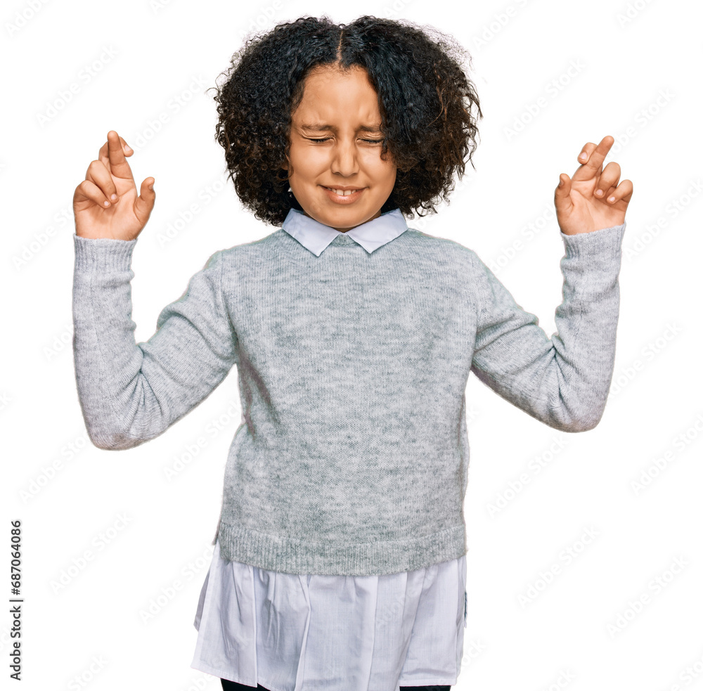 Young little girl with afro hair wearing casual clothes gesturing finger crossed smiling with hope and eyes closed. luck and superstitious concept. Young little girl with afro hair wearing casual clothes gesturing finger crossed smiling with hope and eyes closed. luck and superstitious concept.