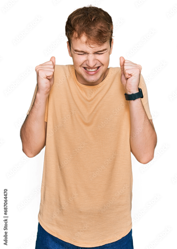 Φωτογραφία Young caucasian man wearing casual clothes excited for success with arms raised and eyes closed celebrating victory smiling