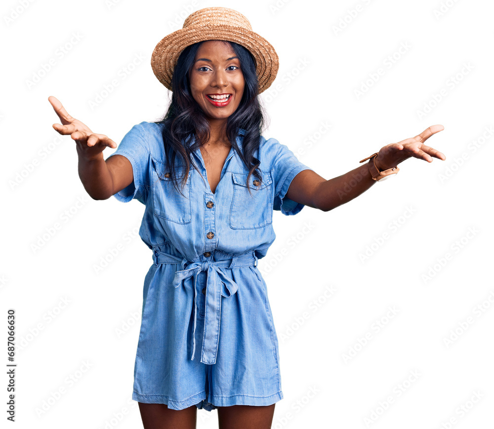 Young indian girl wearing summer hat smiling cheerful offering hands giving assistance and acceptance. Young indian girl wearing summer hat smiling cheerful offering hands giving assistance and acceptance.