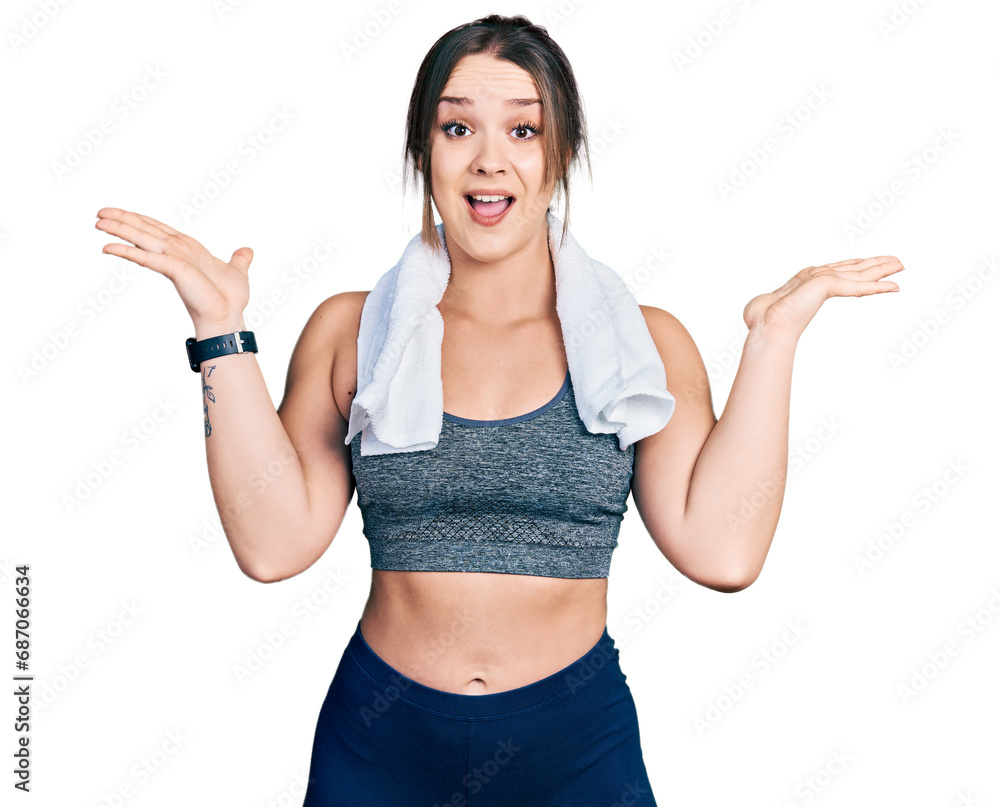 Young hispanic girl wearing sportswear and towel celebrating crazy and amazed for success with arms raised and open eyes screaming excited. winner concept Young hispanic girl wearing sportswear and towel celebrating crazy and amazed for success with arms raised and open eyes screaming excited. winner concept