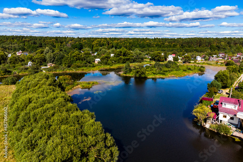 A picturesque colorful view of the river area with densely built coastline. Lake Ogublyanka, Kaluga region, Russia