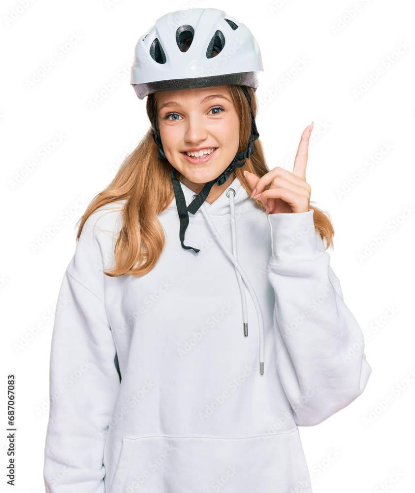 Beautiful young caucasian girl wearing bike helmet pointing finger up with successful idea. exited and happy. number one. Beautiful young caucasian girl wearing bike helmet pointing finger up with successful idea. exited and happy. number one.