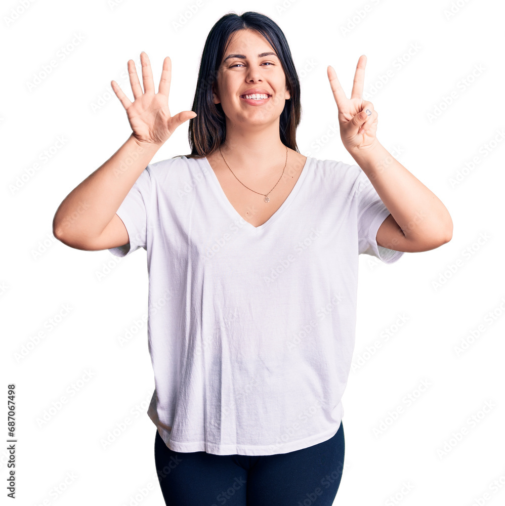 Φωτογραφία Young beautiful brunette woman wearing casual t-shirt showing and pointing up with fingers number seven while smiling confident and happy