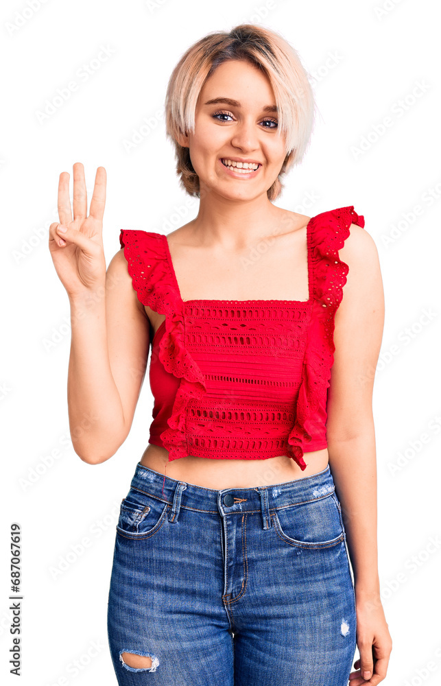 Young beautiful blonde woman wearing casual clothes showing and pointing up with fingers number three while smiling confident and happy. Young beautiful blonde woman wearing casual clothes showing and pointing up with fingers number three while smiling confident and happy.