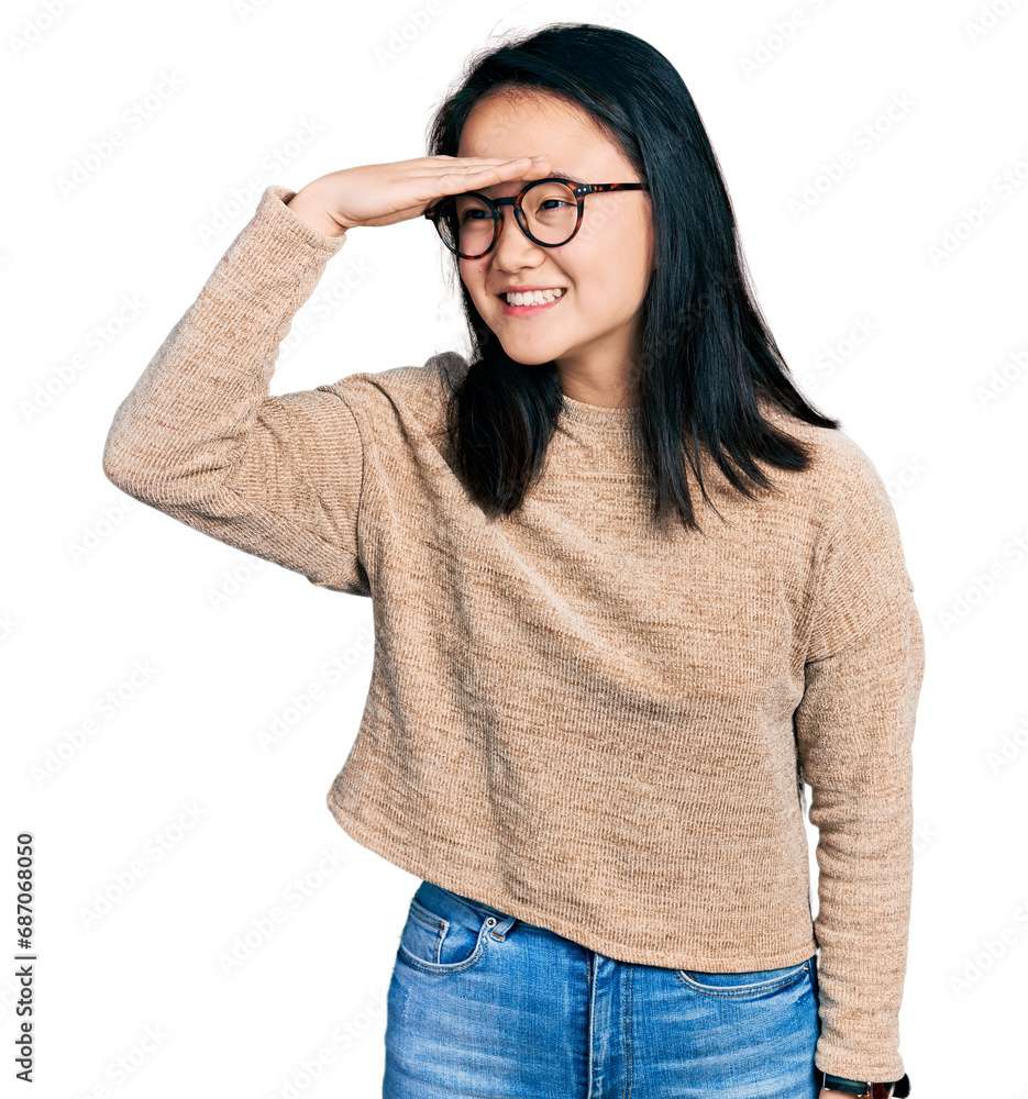 Φωτογραφία Young chinese woman wearing casual sweater and glasses very happy and smiling looking far away with hand over head