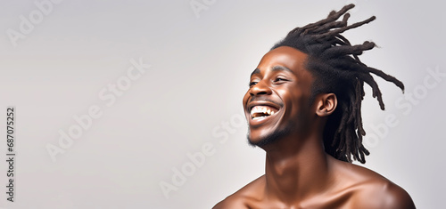Portrait of a young smiling black man with dreadlocks hair. Skin care beauty, skincare cosmetics, isolated over white background. 