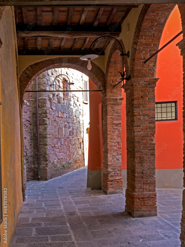 An ancient wooden porch in an alley in the city of Lucca, Tuscany, Italy.