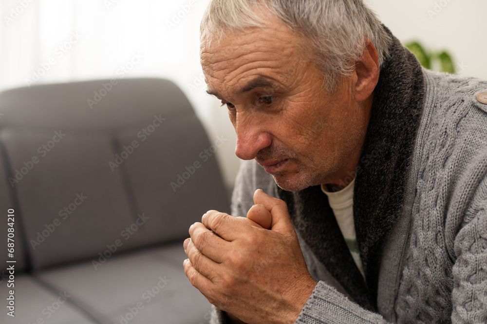 Portrait praying senior man against white background - obrazy, fototapety, plakaty 