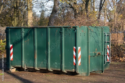 green big garbage bin in the park