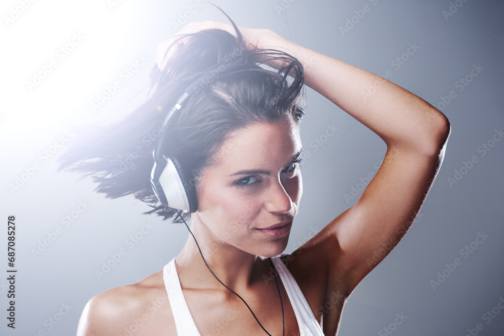 Headphones, woman and portrait with dancing, music and radio in a studio. Smile, happy female person and audio for streaming and podcast with freedom and sound with confidence and grey background Headphones, woman and portrait with dancing, music and radio in a studio. Smile, happy female person and audio for streaming and podcast with freedom and sound with confidence and grey background