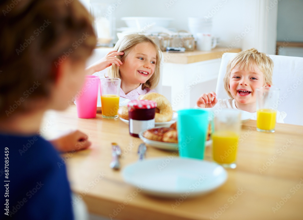 Happy, kitchen and children eating breakfast together for healthy, wellness and diet meal. Smile, laughing and kid siblings bonding and enjoying lunch or brunch by wooden table at modern family home. Happy, kitchen and children eating breakfast together for healthy, wellness and diet meal. Smile, laughing and kid siblings bonding and enjoying lunch or brunch by wooden table at modern family home.