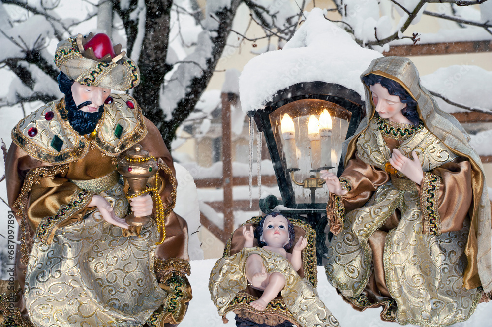 Nativity scene with a snowy landscape in the background.