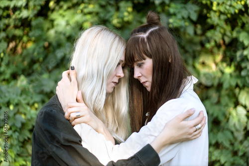 Fashion girls twins posing in nature