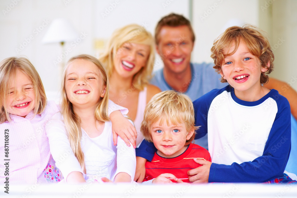 Smile, portrait and parents with children on bed for bonding, relaxing and spending time together. Happy, love and young mother and father resting with kids from Australia in bedroom at family home. Smile, portrait and parents with children on bed for bonding, relaxing and spending time together. Happy, love and young mother and father resting with kids from Australia in bedroom at family home.