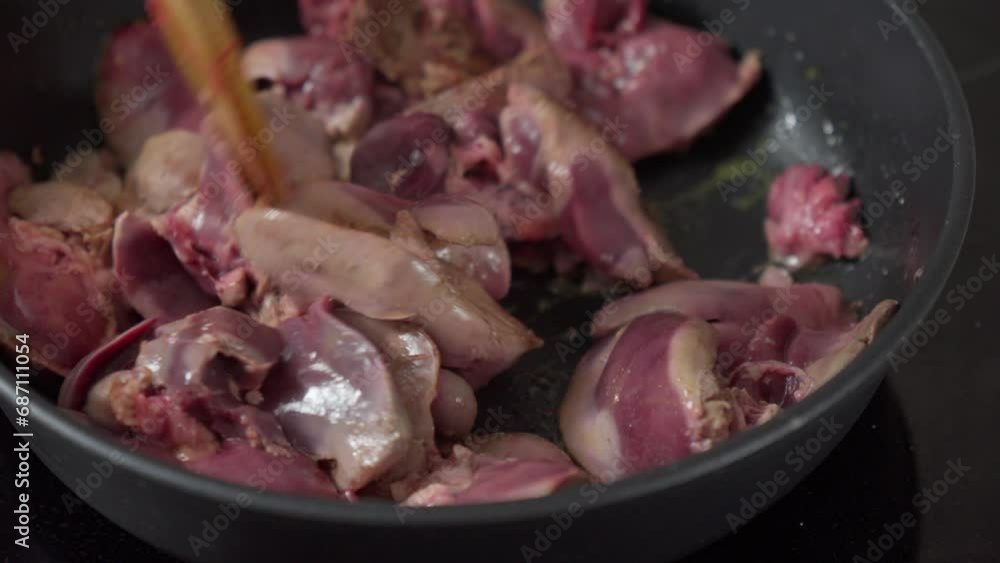 Cooking chicken liver in a frying pan in close-up. Flavors and Juicy Tenderness. Selective focus Cooking chicken liver in a frying pan in close-up. Flavors and Juicy Tenderness. Selective focus