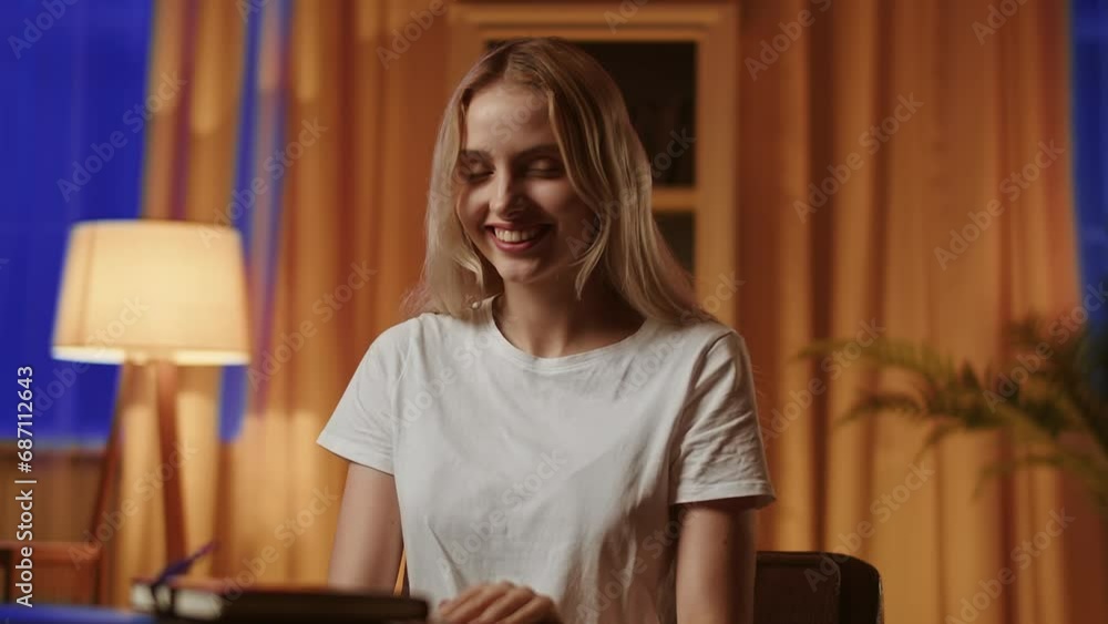 A smiling girl blonde student rubs hands contentedly, rejoices at passing exam perfectly. A pretty young lady in bliss and emotionally filled after a successful date, acceptance to the desired job or A smiling girl blonde student rubs hands contentedly, rejoices at passing exam perfectly. A pretty young lady in bliss and emotionally filled after a successful date, acceptance to the desired job or