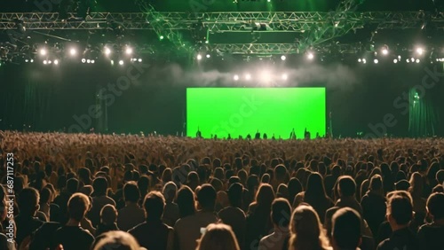 Back view huge crowd of people with phones in hands at live concert or show green screen 4k footage photo
