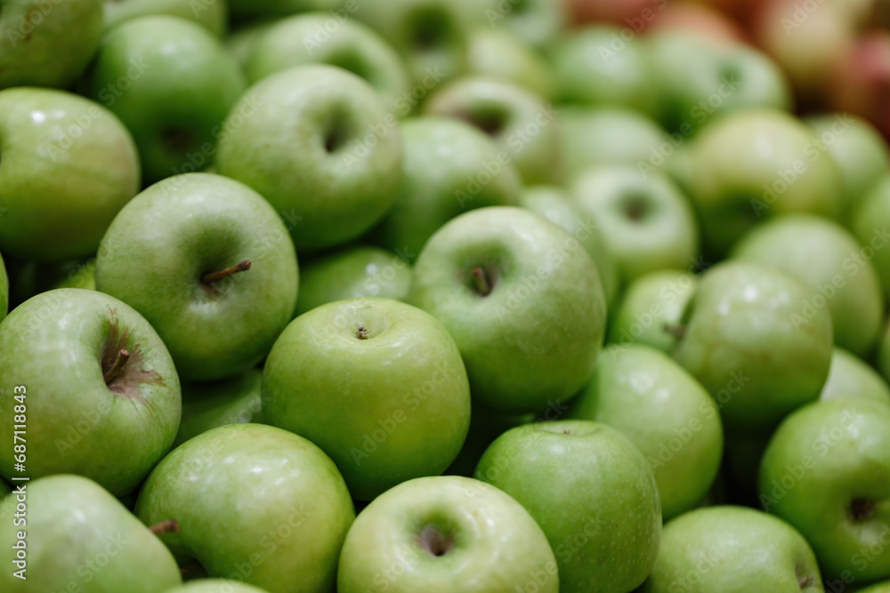 Selective focus of fresh green apples background, close up. Backgrounds of ripe juicy apples fruits from market. Picked apple, natural freshness, vegetarian food, diet. Jewish New Year, Rosh Hashanah Selective focus of fresh green apples background, close up. Backgrounds of ripe juicy apples fruits from market. Picked apple, natural freshness, vegetarian food, diet. Jewish New Year, Rosh Hashanah
