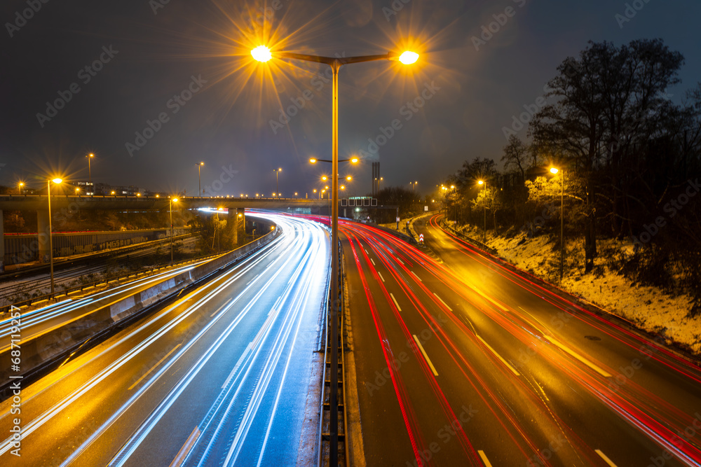 City motorway in rush hour in the evening with motion light trails and moving traffic