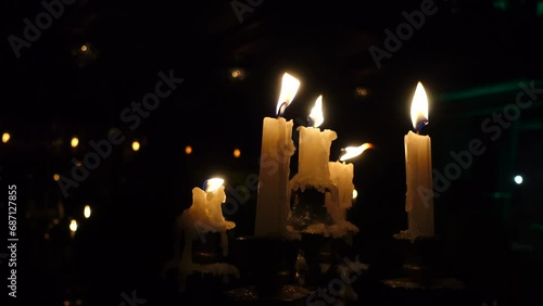 Burning candles on candelabra in night, melted wax. photo
