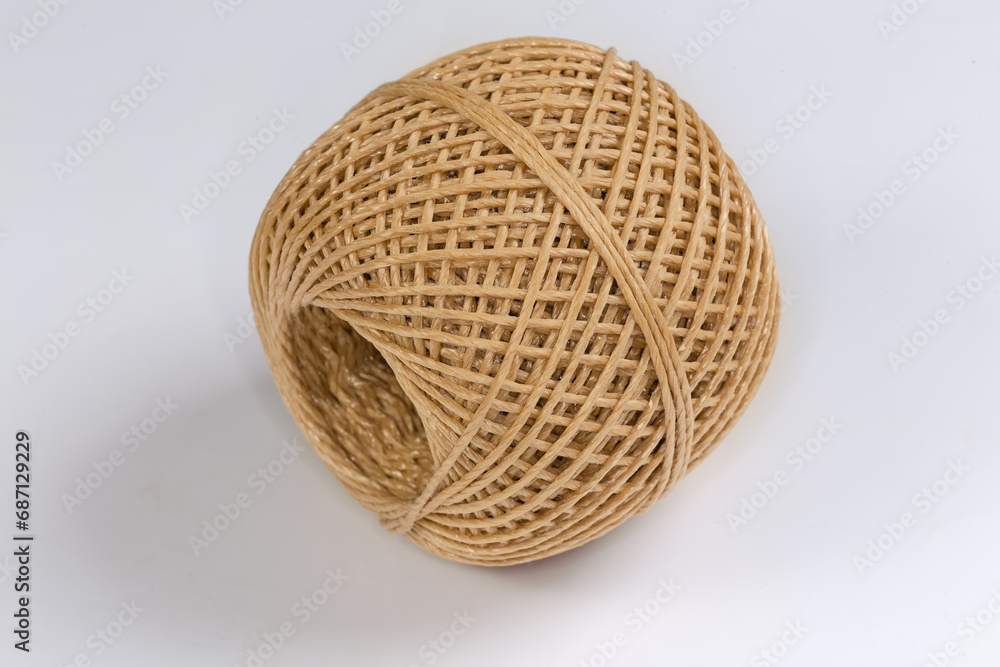 Skein of brown synthetic twine on a white background Skein of brown synthetic twine on a white background