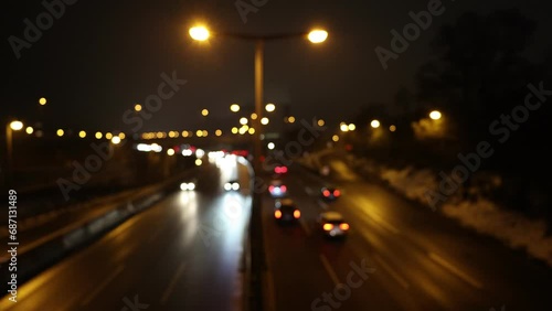 City highway in in the evening rush hour with moving traffic and blurred cars and lights (out of focus) photo