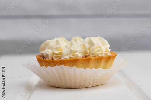 Tart with white cream close-up. Cake on a light background, sweetness, dessert, soft focus.