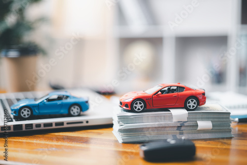Car loan,money, banknote on agreement document or car insurance application form. Saving money for car concept, trade car for cash concept, finance concept.