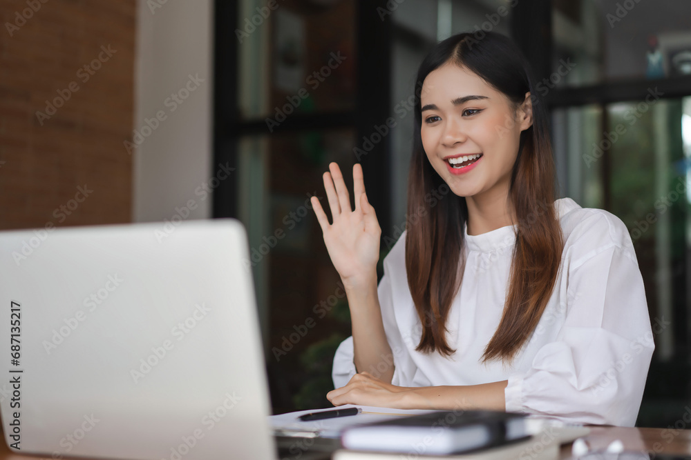 Businesswomen meeting and greeting with colleague in video call while working in outside office Businesswomen meeting and greeting with colleague in video call while working in outside office