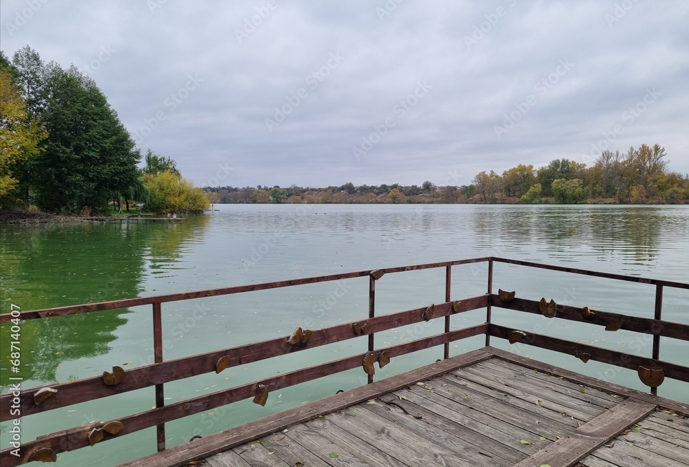 Fototapeta premium Landscape of the forest and lake from the dock.