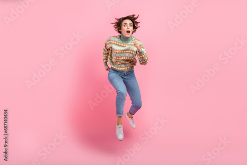 Full body size photo of running jump air nervous girl stressed scared her drunk husband dissatisfied isolated on pink color background photo