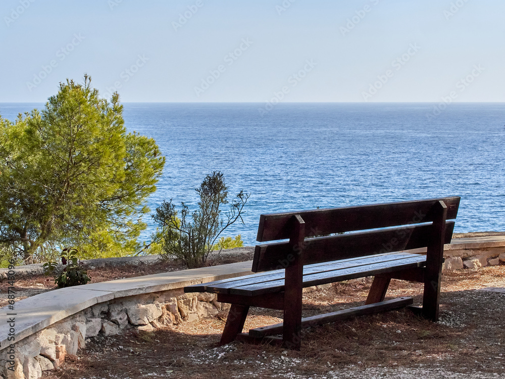 Wooden bench looking to the Mediterranean sea in Benissa Ecological Walk, Paseo Ecologico in Spanish. Benisa, province of Alicante, Costa Blanca, Comunidad Valenciana, Spain, Europe