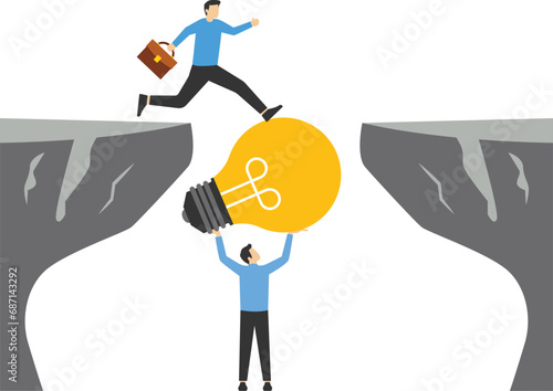 Teamwork concept,Businessman holding light bulb bridging the gap for partner walking across cliff, business support and teamwork vector concept

