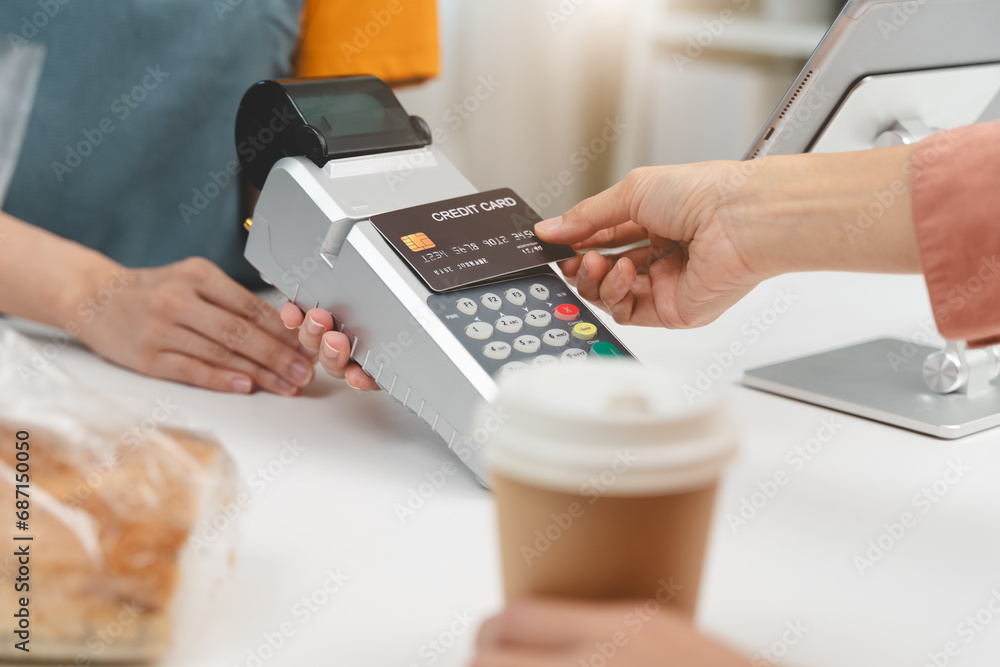 Cashless payment in shopping concept, Close-up hands using credit card pay at cafe. Cashless payment in shopping concept, Close-up hands using credit card pay at cafe.