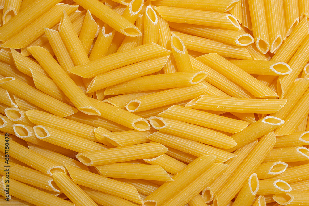 Uncooked Penne Rigate Pasta: A Culinary Canvas of Penne Macaroni, Creating a Lively and Textured Background for Gourmet Cooking. Dry Pasta. Raw Macaroni - Top View, Flat Lay Uncooked Penne Rigate Pasta: A Culinary Canvas of Penne Macaroni, Creating a Lively and Textured Background for Gourmet Cooking. Dry Pasta. Raw Macaroni - Top View, Flat Lay