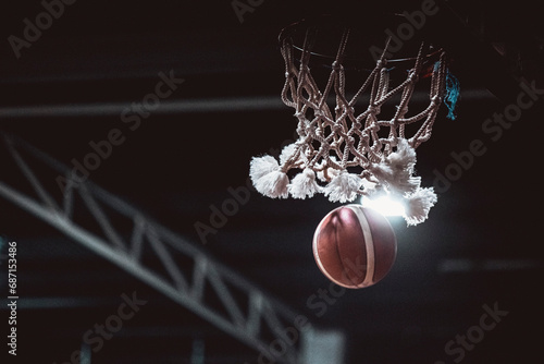 Basketball hoop and ball in the net low angle © Claude Kabengera