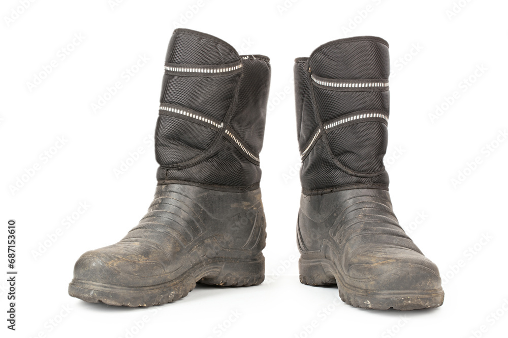 Dirty insulated old boots on a white background. Hiking boots.