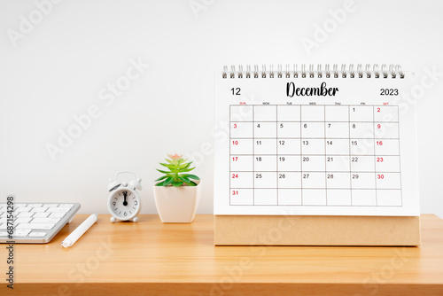 December 2023, Monthly desk calendar for 2023 year on wooden table.