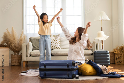 Portrait happy love asian family mother with little asian girl traveler packing stuff and outfit clothes in suitcases travel bag luggage for summer holiday weekend tourist vacation trip at home.travel